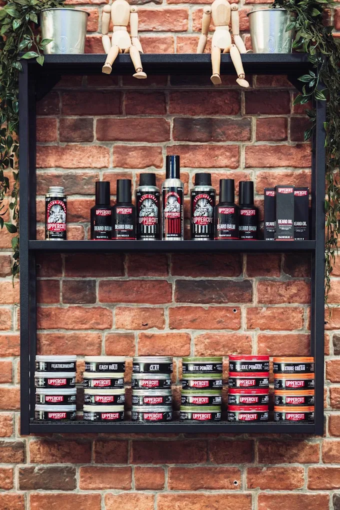 Grooming products on the barbershop’s brick wall shelves